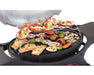 Seafood grilling on a barbecue rack with prawns, lobster, salmon, scallops, and lime halves